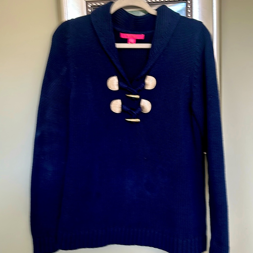 Lilly Poulter navy Sala look cotton knit, navy sweater with gold toggles on it